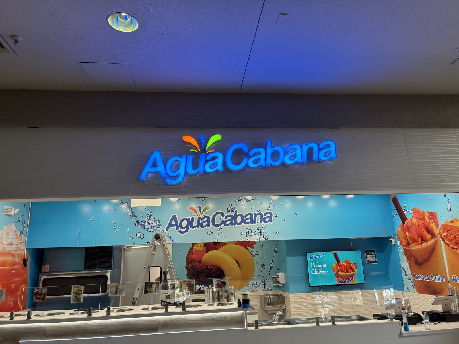 The finished Agua Cabana face-lit channel letters installed and illuminated above the storefront