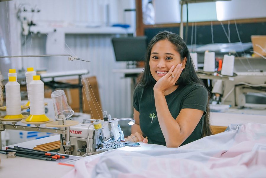 Studio OntheRock team member sewing fabric graphics