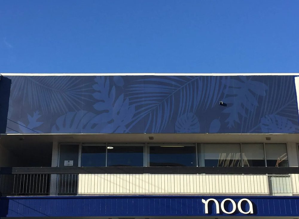 Large palm-frond building wall wrap by Studio OntheRock